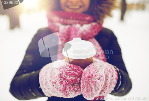 Image of close up of hand with coffee outdoors in winter