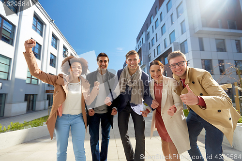 Image of group of people showing thumbs up in city