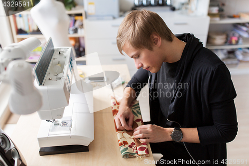 Image of fashion designer with making dress at studio