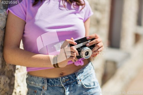 Image of close up of woman with vintage camera outdoors