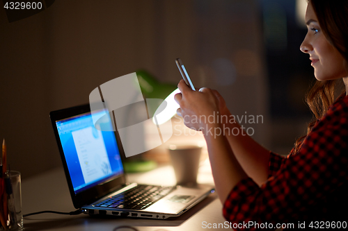 Image of student woman with laptop and smartphone at home