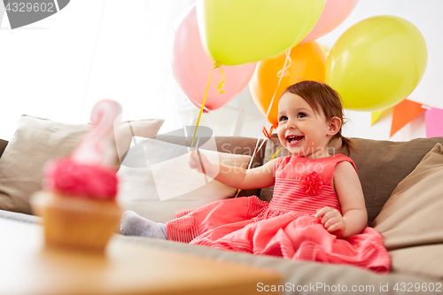 Image of happy baby girl on birthday party at home