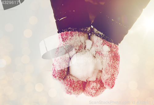 Image of close up of woman holding snowball outdoors