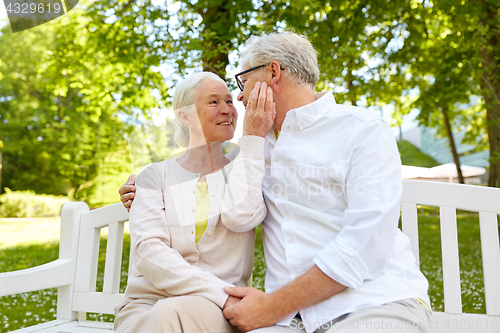 Image of happy senior couple hugging in city park