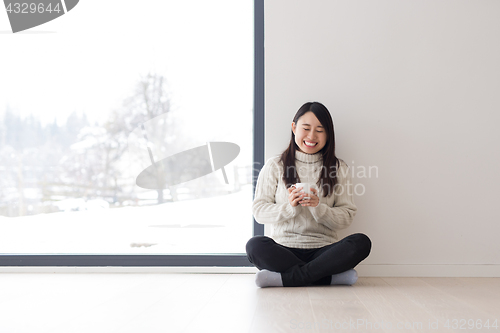 Image of asian woman enjoying morning coffee