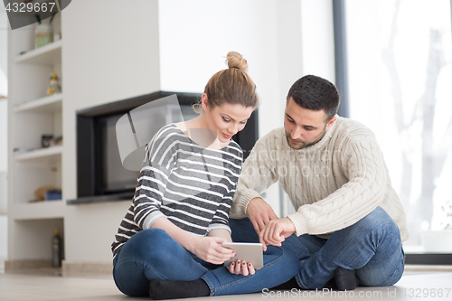 Image of Young Couple using digital tablet on cold winter day