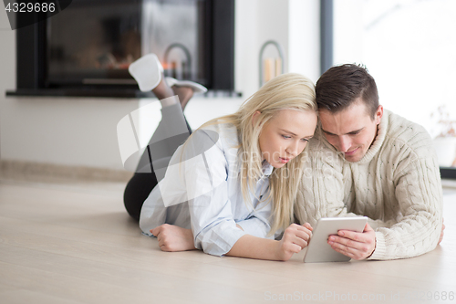 Image of Young Couple using digital tablet on cold winter day