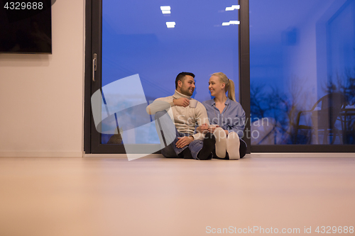 Image of happy couple in front of fireplace