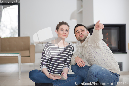 Image of Young Couple using digital tablet on cold winter day