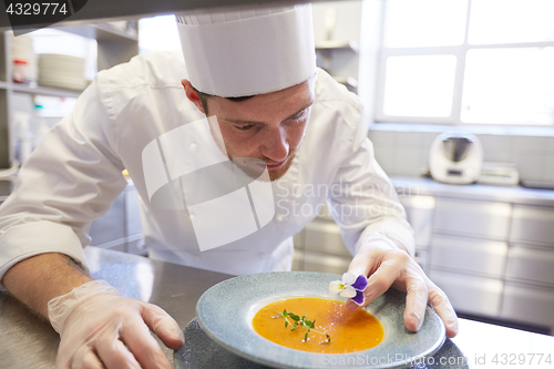 Image of happy male chef cooking food at restaurant kitchen