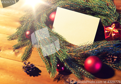 Image of natural green fir wreath with note on wooden board