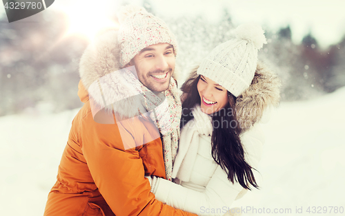 Image of happy couple hugging and laughing in winter