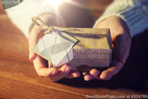 Image of close up of woman with christmas gift or parcel