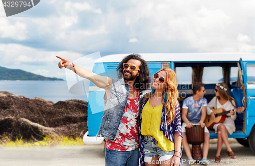 Image of happy hippie couples and minivan on island