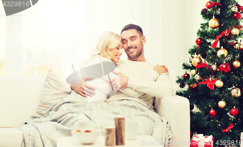 Image of happy couple at home with christmas tree