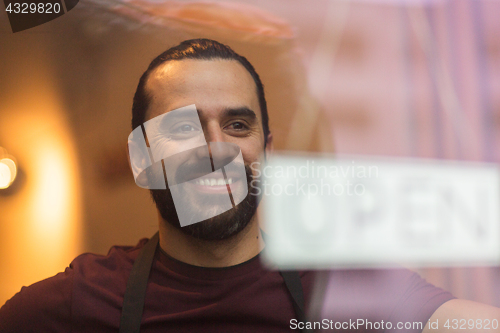 Image of man with open banner at bar or restaurant window