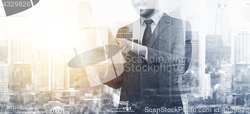 Image of smiling businessman with tablet pc computer