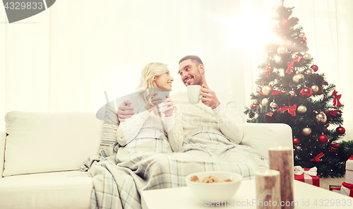 Image of happy couple at home with christmas tree