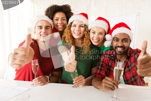 Image of happy team celebrating christmas at office party