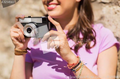 Image of close up of woman with vintage camera outdoors