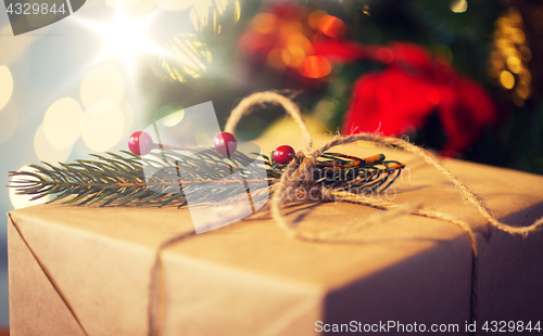 Image of close up of christmas gift with fir brunch