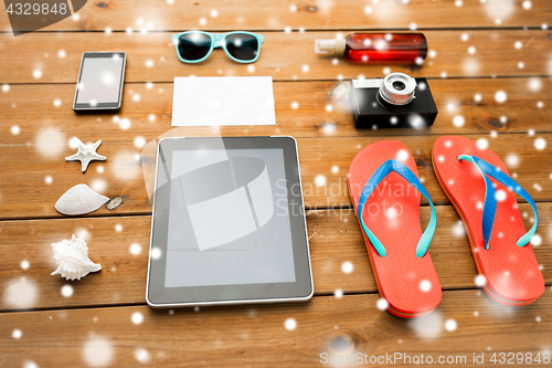 Image of tablet pc and beach stuff