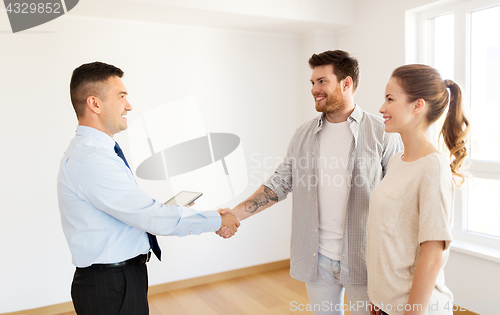 Image of man and realtor shaking hands at new home