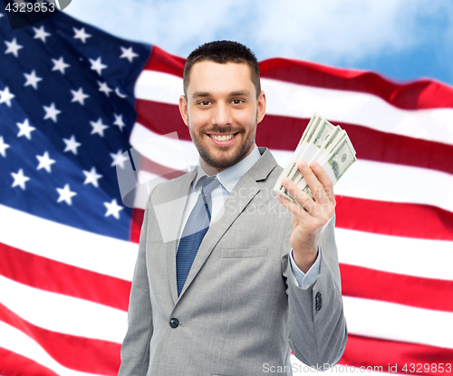 Image of smiling businessman with american dollar money