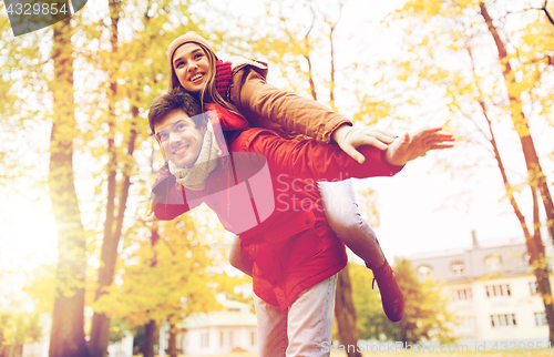 Image of happy young couple having fun in autumn park