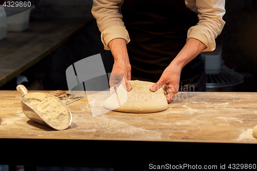 Image of chef or baker cooking dough at bakery