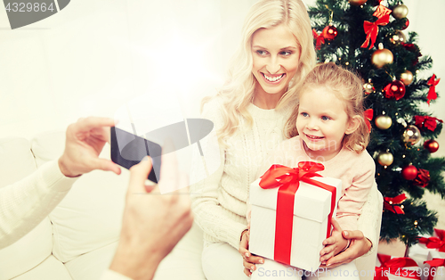 Image of family taking picture with smartphone at christmas