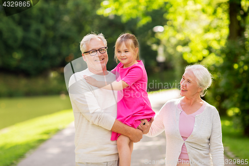 Image of senior grandparents and granddaughter at park