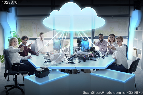 Image of happy business team with cloud computing hologram