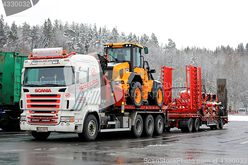 Image of Scania Truck Hauls Heavy Machinery in Winter