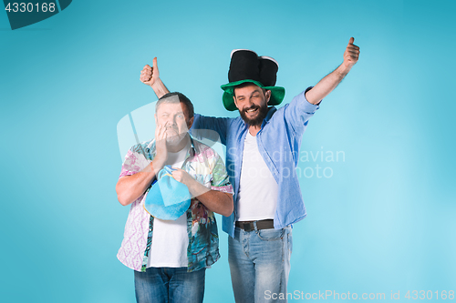 Image of The two football fans over blue