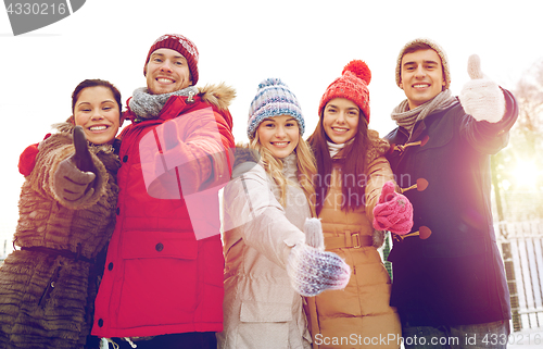 Image of group of smiling men and women in winter forest