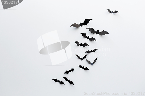 Image of black paper bats over white background