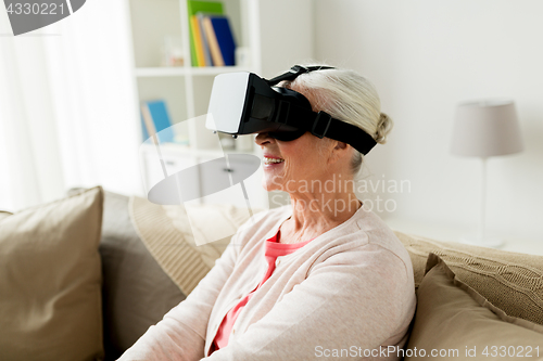 Image of old woman in virtual reality headset or 3d glasses