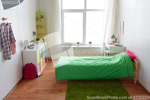 Image of kids room interior with bed, table and accessories