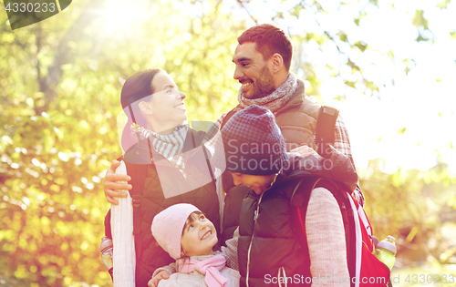 Image of happy family with backpacks hiking