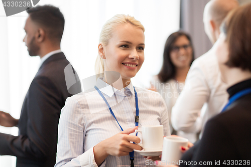 Image of business people with conference badges and coffee