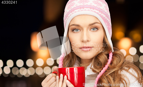 Image of close up of woman with mug over christmas lights