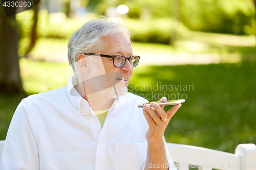 Image of old man using voice command recorder on smartphone