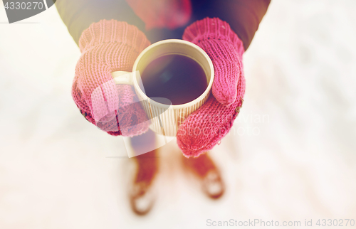 Image of close up of woman with tea mug outdoors in winter