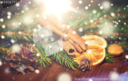 Image of christmas fir branch, cinnamon and dried orange