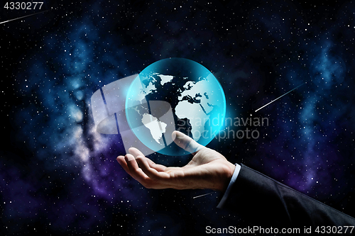 Image of close up of businessman hand with earth projection