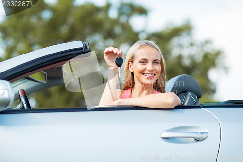 Image of happy young woman with convertible car key