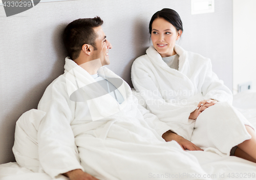 Image of happy couple in bed at home or hotel room