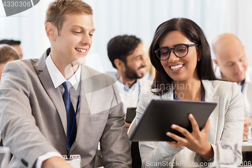 Image of team with tablet pc at business conference