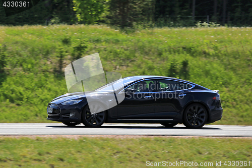 Image of Black Tesla Model S Electric Car at Speed